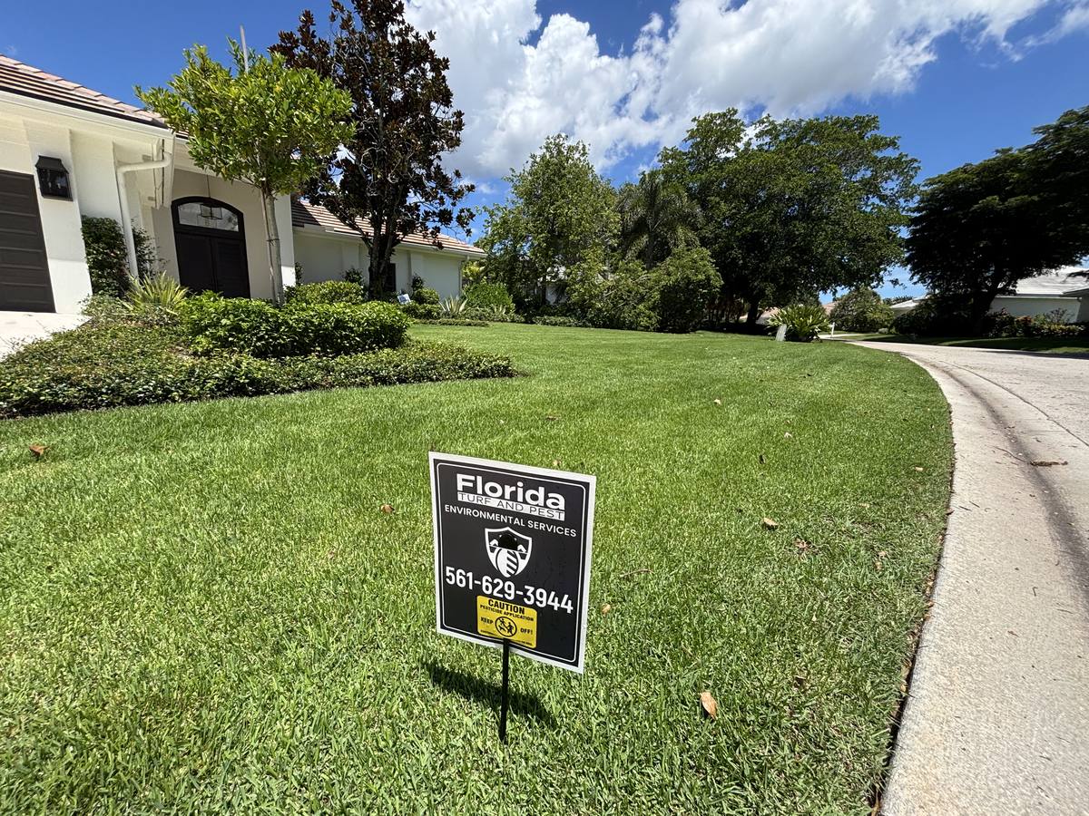 Florida Turf and Pest service sign posted in a thick, healthy front lawn